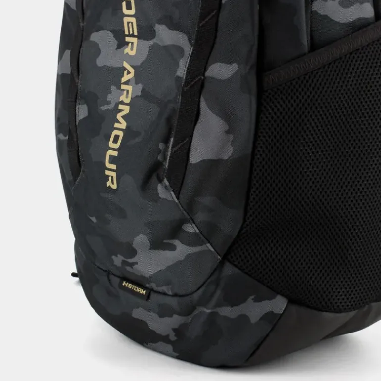 UA HUSTLE 6.0- ZAINI BLACK/METALLIC GOLD 1384672